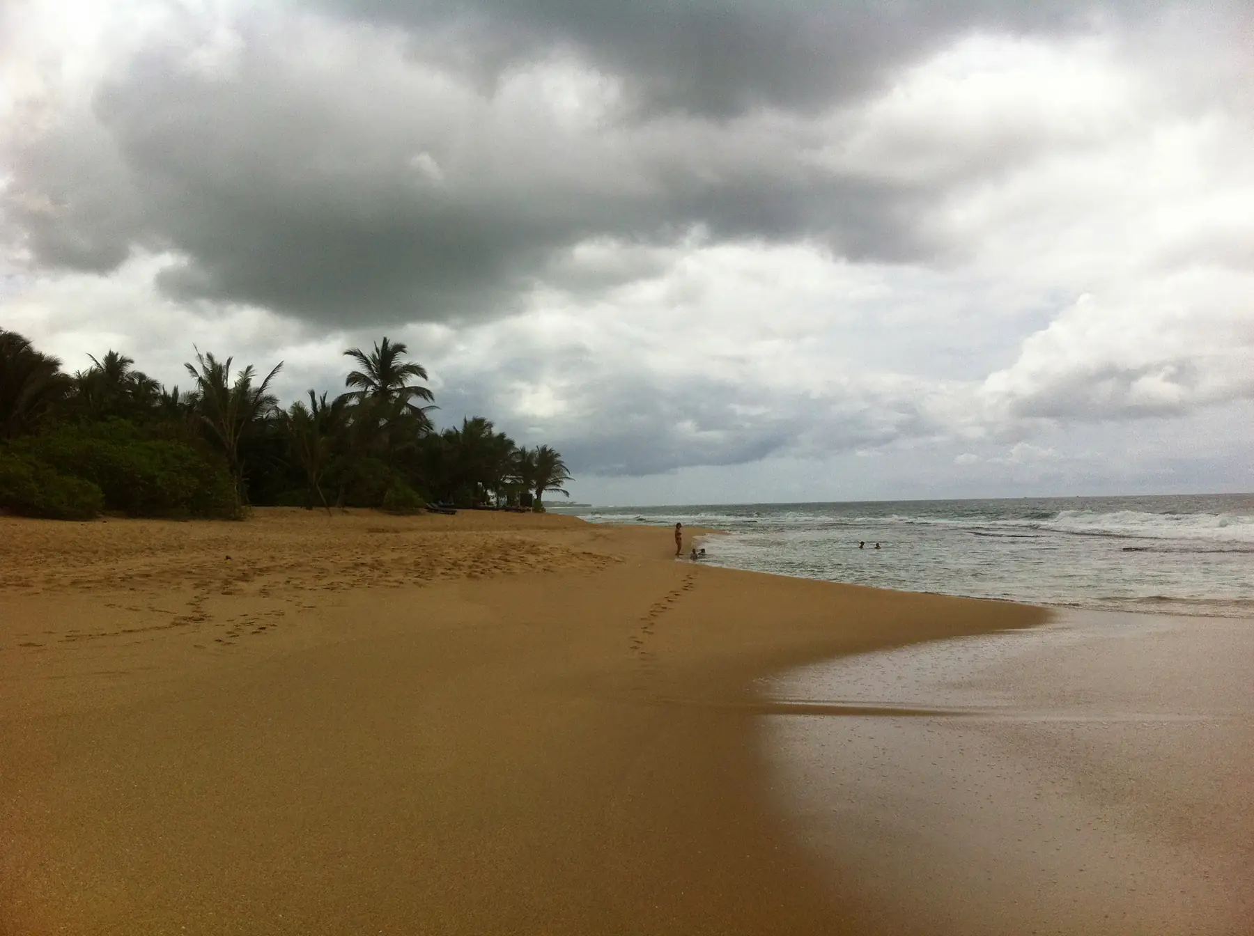 Beach and sea at Hambantota under cloud.