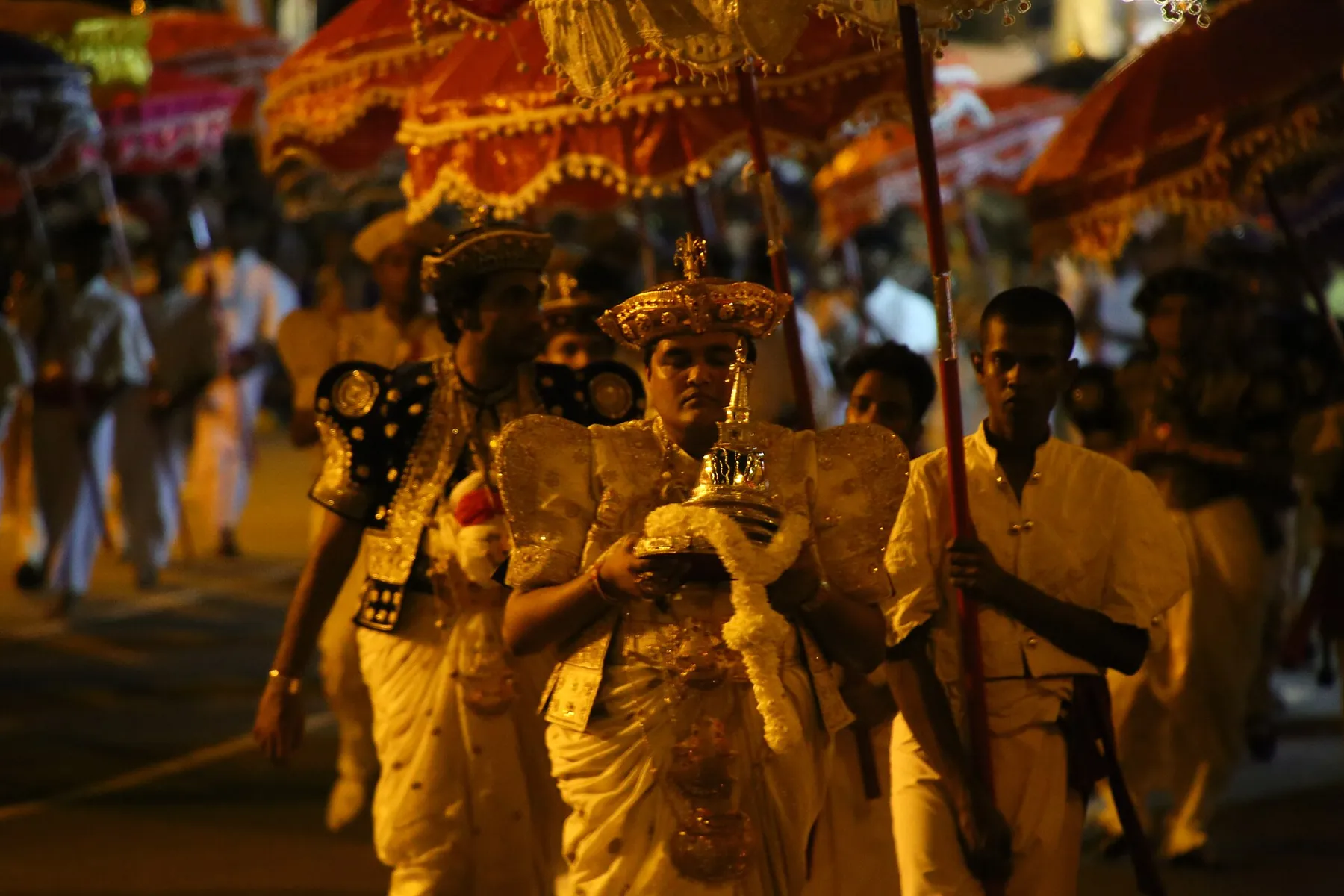 A relic bearer and attendants under parasols in the Navam Perahera, Colombo.