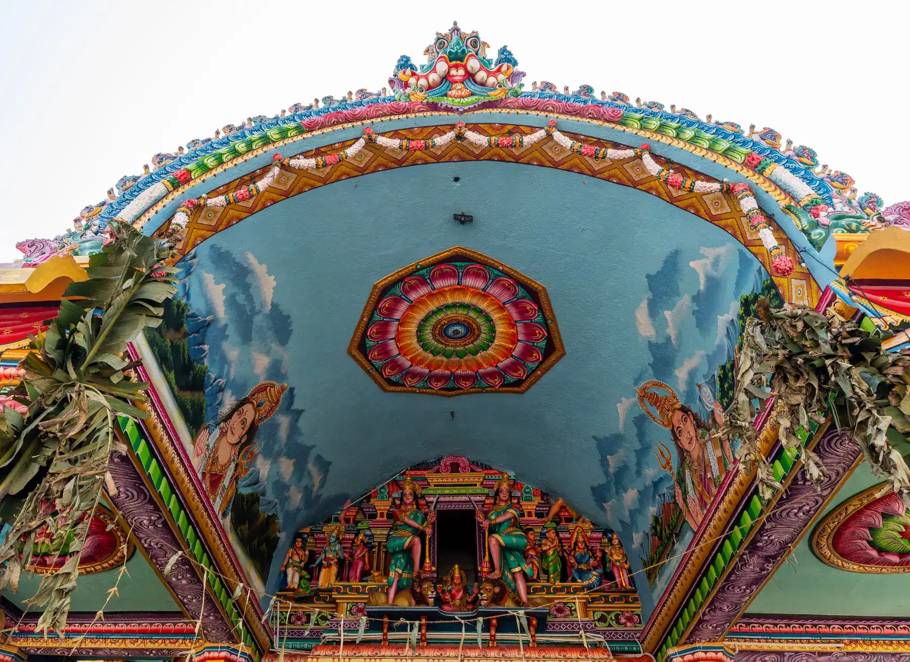 Colourful painted ceiling artwork inside a Hindu temple.