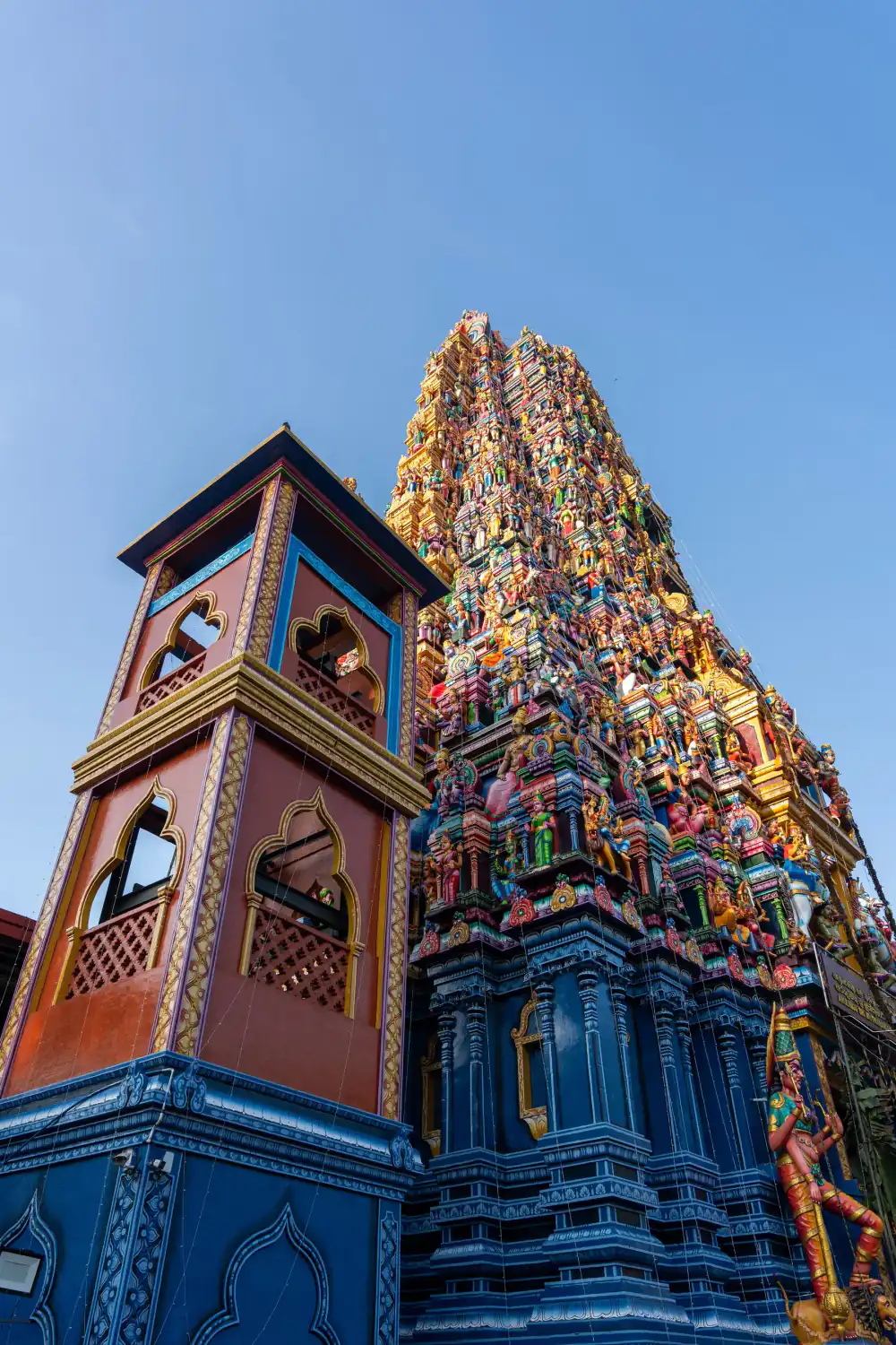 A vibrant painted Hindu temple gopuram tower.