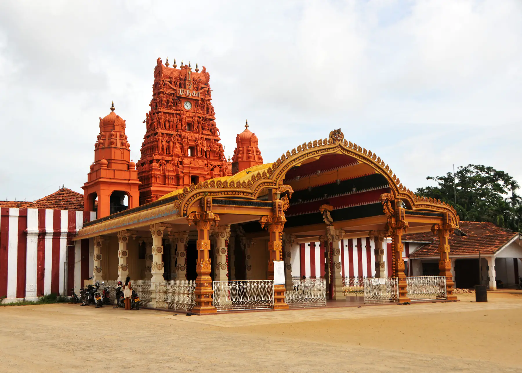 The golden-arched front entrance and red gopuram of Nallur Kandaswamy Kovil, Jaffna.
