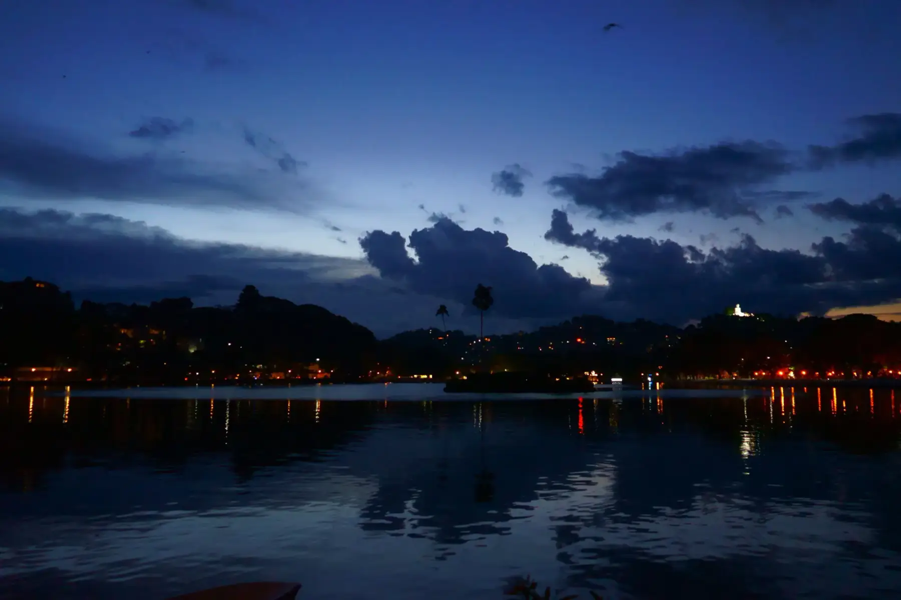 Kandy Lake at dusk with colour in the reflections.